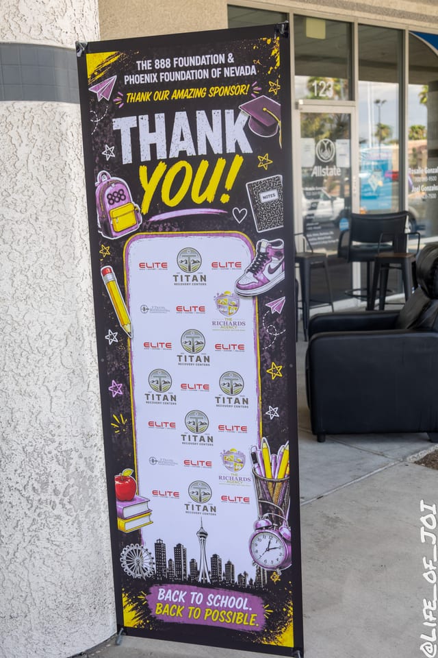 The 888 Foundation and Phoenix Foundation of Nevada sponsor banner outside The Blade Barbershop, reading Back to School, Back to Possible.