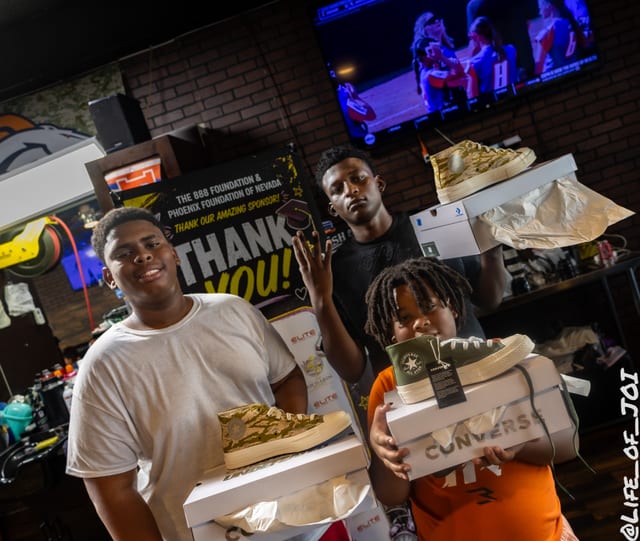 Kids show off new sneakers from the back to school giveaway.
